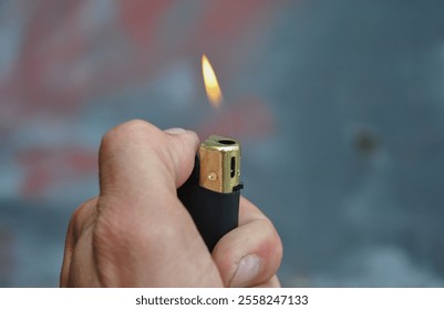 hand holding lighter. lighter flame close-up. selective focus - Powered by Shutterstock