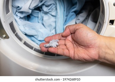 Hand Holding Lint Removed From Laundry Dryer Filter