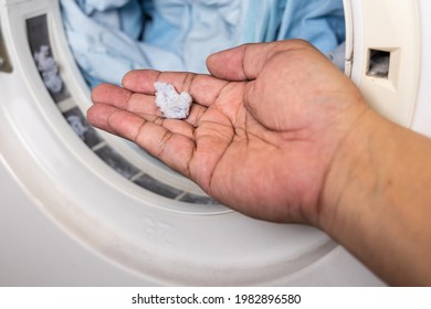 Hand Holding Lint Removed From Laundry Dryer Filter