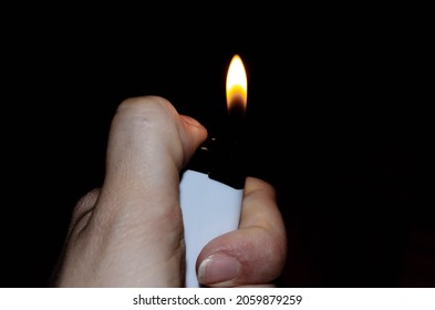 A Hand Is Holding Lit Lighter