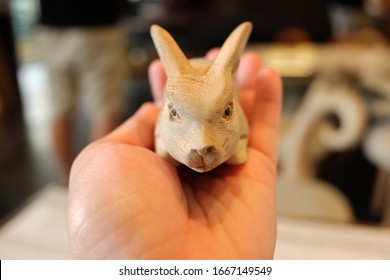 Hand Holding Little Wood Carving Rabbit Is Hanmade Of Figure Animal In Vintage Souvenir Shop At Thailand