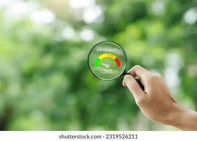hand holding a magnifying glass to check the  good air quality and clean outdoor air quality safe from pollution dust PM 2.5 - Shutterstock ID 2319526211