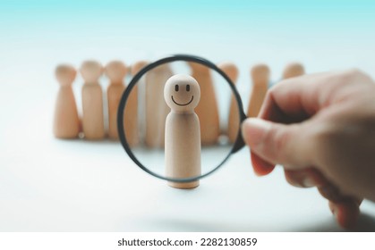 Hand holding a magnifying glass emotion face icon, in human resource search, talent management. - Shutterstock ID 2282130859