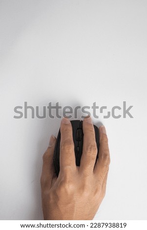 Hand holding and make a secure grip on wireless mouse. Isolated. White background.