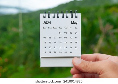 Hand holding May 2024 white calendar with nature background. Holiday and calendar concept. - Powered by Shutterstock