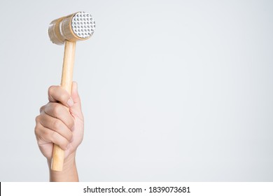 Hand Holding Meat Tenderizer Mallet Or Food Hammer For Cooking On White Background