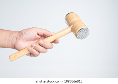 Hand Holding Meat Tenderizer Mallet Or Food Hammer For Cooking On White Background