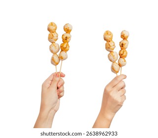 Hand holding meatball stick with spicy sauce isolated on white background.