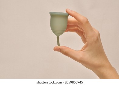 hand is holding menstrual cup for woman zero waste periods