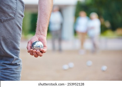 Hand Holding A Metal Ball For Playing Boule