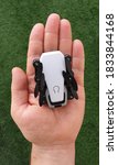 Hand holding micro foldable pocket drone gadget