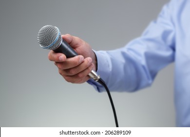 Hand Holding A Microphone Conducting A Business Interview Or Press Conference