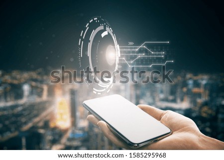 Hand holding mobile phone with creative round button. Future and inovation concept.