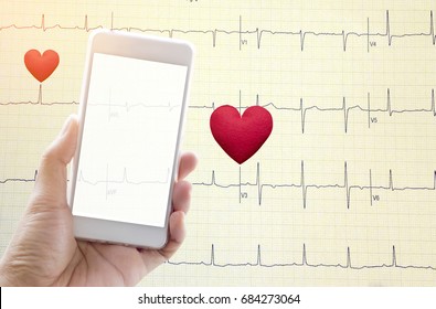 Hand Holding Mobile Phone With Red Heart On Echo Cardiogram Graph Background.