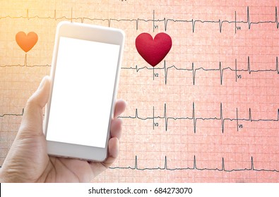 Hand Holding Mobile Phone With Red Heart On Echo Cardiogram Graph Background.