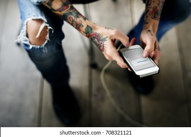 Hand Holding Mobile Phone Showing Downloading Data Screen