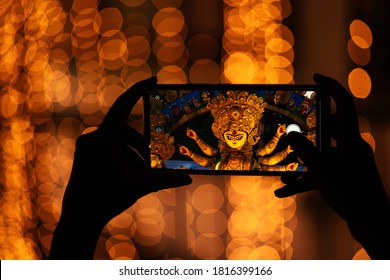 Hand Holding Mobile Phone And Taking Photos Of Goddess Durga Idol At A Pandal. Durga Puja Memories Of 2019 Is The Biggest Religious Festival Of Hinduism And Bengali Community.