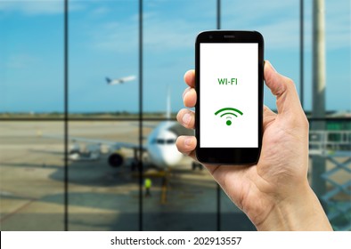 Hand Holding Mobile Smart Phone With Connect Wifi On The Airport