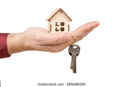 Hand Holding Model House And Keys. Close-up Of Hand Holding Keys And Wooden House Model Isolated On White Background. Mortgage Loan Approval Home Loan And Insurance Concept.