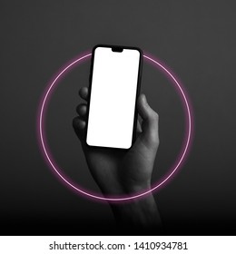 Hand Holding Modern Smartphone With A Blank White Screen And Neon Light Glow