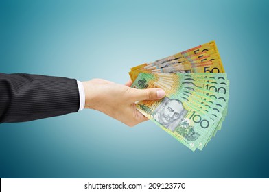 Hand holding money - Australian dollar (AUD) bills