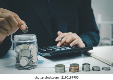 Hand Holding Money Coin Saving Investment In Jar.Business Finance Accounting Economy Concept.