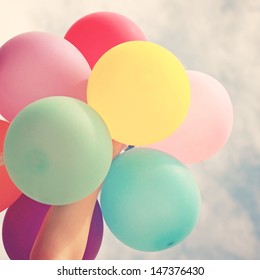 Hand Holding Multicolored Balloons With Retro Instagram Filter Effect, Summer Or Holiday Concept