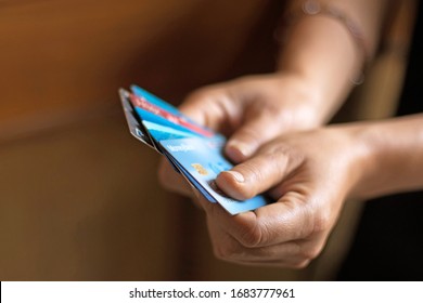 Hand Holding Multiple Credit Cards