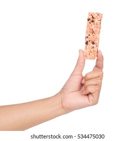 Hand Holding Munchies Health Cereal Candy Bar Isolated On White Background.