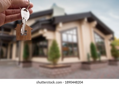 Hand holding up new house key. Real state concept - Shutterstock ID 1890448204