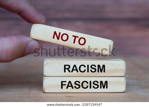 Hand holding no to racism and fascism. Rights\
protection culture\
concept.