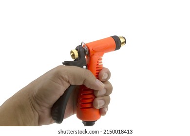 Hand Holding Nozzle On A Hose For Watering. Hose Nozzle Spraying Water Isolated On White Background.