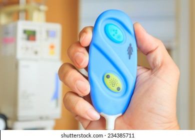 hand holding nurse call button