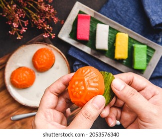 Hand Holding Nyonya Kuih On Dark Background