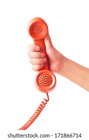 Hand Holding An Old Orange Telephone Isolated On White