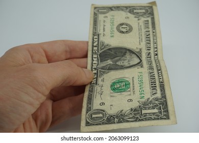 Hand Holding One Dollar Bill