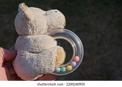 Hand Holding One Small White Plush Dog Toy