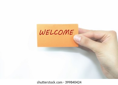 hand holding orange card written welcome over isolated - Shutterstock ID 399840424