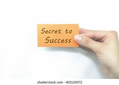  hand holding orange card written secret to success over isolated - Shutterstock ID 403135072