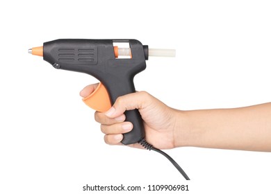 hand holding Orange Electric hot glue gun isolated on a white background. - Shutterstock ID 1109906981