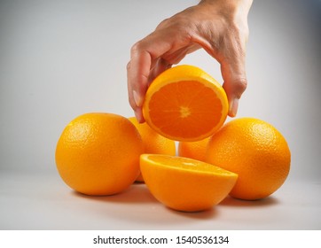 Hand Holding An Orange Friut 