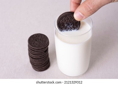 Hand Holding Oreo Chocolate Cream Cookies Dunk To Glass Of Milk.31- 01 - 2022 Istanbul - Turkey