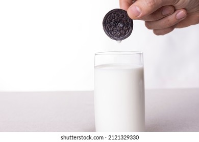 Hand Holding Oreo Chocolate Cream Cookies Dunk To Glass Of Milk.31- 01 - 2022 Istanbul - Turkey