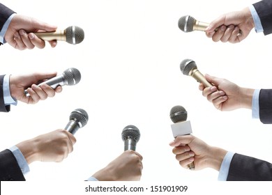 hand holding out a microphone isolated on white background