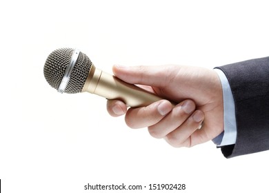 Hand Holding Out A Microphone Isolated On White Background