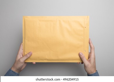 Hand Holding Padded Envelope Mock-up, Ready To Replace Your Design.