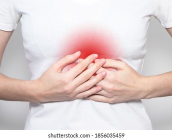 Hand holding pain point, suffering from heart or solar plexus ache. - Shutterstock ID 1856035459