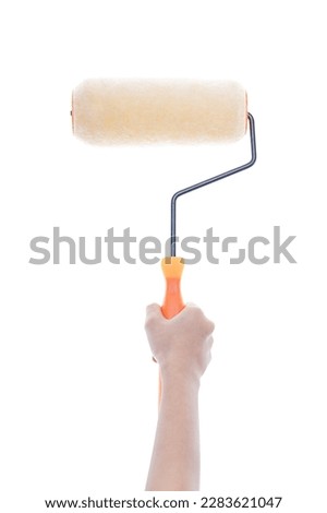 Hand holding a paint roller isolated on white background with clipping path.