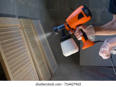  Hand Holding Paint Spray, Painting Wood In Concrete Building