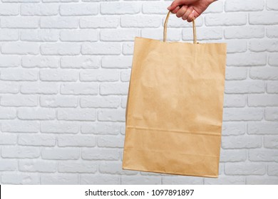 Hand Holding Paper Bag